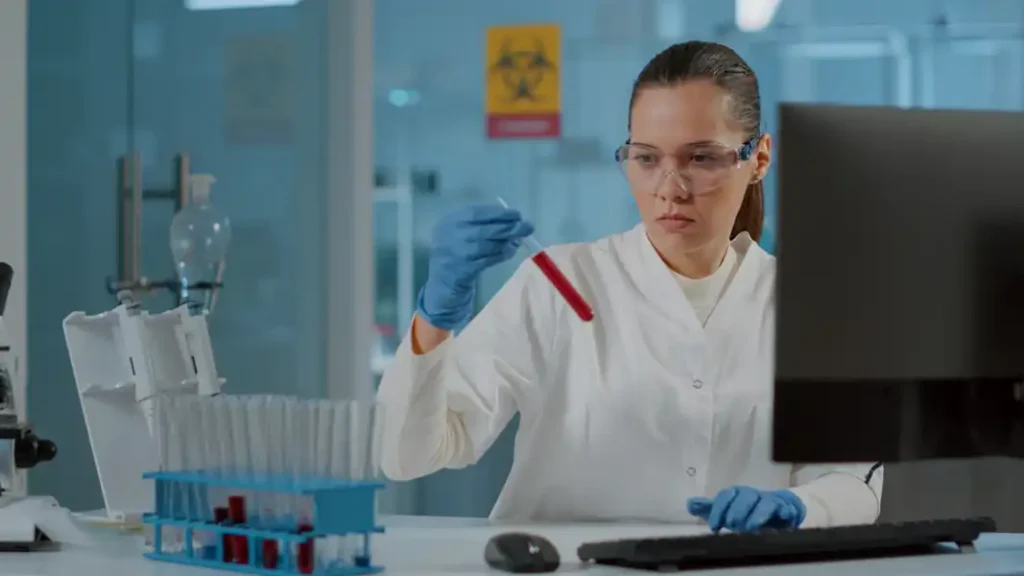 Technicians preparing hot lab facility in Oman including radiation shielding, ventilation systems, and work surface installation for nuclear medicine use